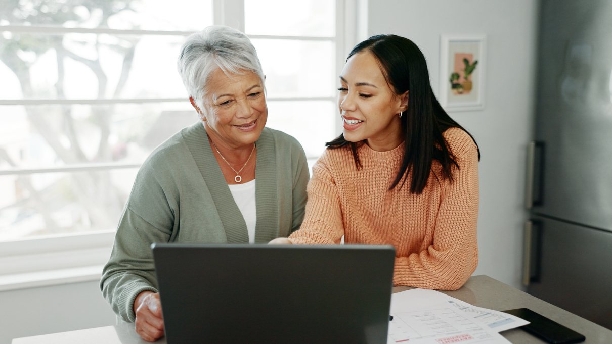 Daughter working with older mom on computer